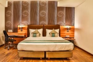 Postel nebo postele na pokoji v ubytování T24 Residency Mumbai International Airport Hotel
