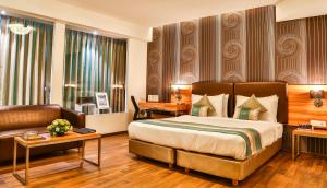 Postel nebo postele na pokoji v ubytování T24 Residency Mumbai International Airport Hotel