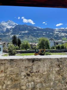 a view from a stone wall with mountains in the background at Valmaison - your cottage in the historic center in Aosta