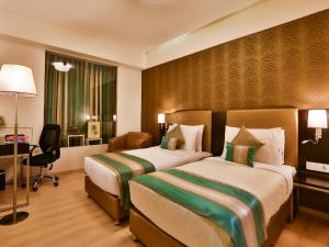 Postel nebo postele na pokoji v ubytování T24 Residency Mumbai International Airport Hotel