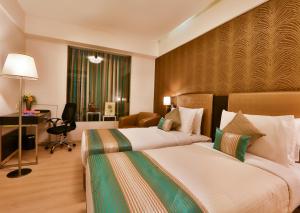 Postel nebo postele na pokoji v ubytování T24 Residency Mumbai International Airport Hotel