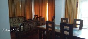 a dining room with a wooden table and chairs at Ohiya View Resort in Ohiya