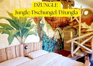 a bedroom with a jungle disney themed mural at Hotel Kocourkov in Hlinsko