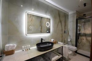 a bathroom with a sink and a toilet and a mirror at Hotel Baia Flaminia in Pesaro +143 photos