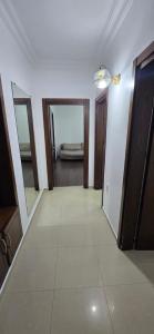 a hallway with two doors and a room with a bed at vapollo apartment in Batumi