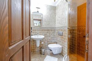 a bathroom with a toilet and a sink at Casa Roma Boutique Hotel in Bodrum City