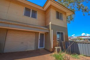 a house with a roll up garage door at Terrific Townhouse 3x2 in CBD in Port Hedland