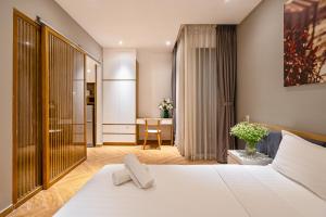 Ένα ή περισσότερα κρεβάτια σε δωμάτιο στο Sunshine Residences By 5H