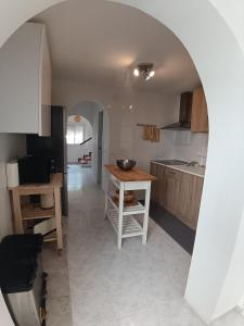 a kitchen with an archway and a table in a room at La Casa de Gigi in Nerja