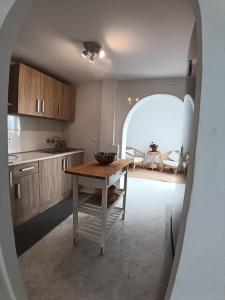 a kitchen with a table in the middle of a room at La Casa de Gigi in Nerja