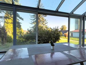 a room with a table and large glass windows at Hesselberg-Oase Ferienhof Hüttner in Röckingen +29 photos