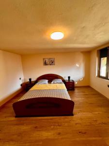 a bedroom with a bed in the middle of a room at CASA Maria in Orlat +20 photos