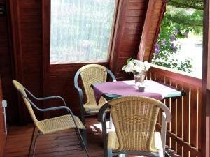 a table and chairs on the porch of a house at Ferienhaus Christina in Medebach