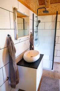 a bathroom with a sink and a mirror at GLAMPING BRUNDO - Tents and Cottage with SAUNA & JACUZZI in Kostel +60 photos