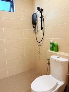 a shower in a bathroom with a toilet at Jeff & Ricky Homestay143-Kenny Hiil Residence in Kuching
