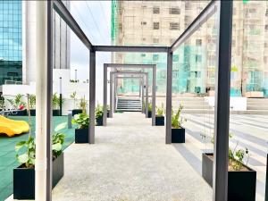 a corridor in a building with potted plants at Jeff & Ricky Homestay143-Kenny Hiil Residence in Kuching