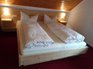 a bed with two pillows on it in a room at Ferienwohnung, Furtwangen in Furtwangen