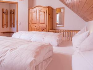 a bedroom with two beds and a mirror at Ferienwohnung, Furtwangen in Furtwangen
