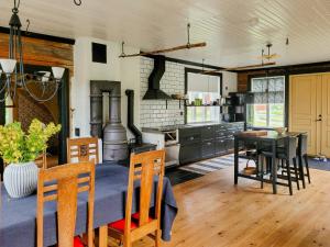 a kitchen with a table and a dining room at Rural 19Th Century House Near Götlunda in Arboga +8 photos