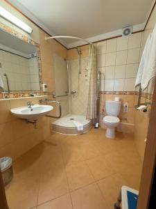 a bathroom with a sink and a toilet and a shower at Hotel Basztowy in Sandomierz +58 photos