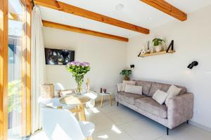 a living room with a couch and a table at Casa Duna Domburg in Domburg