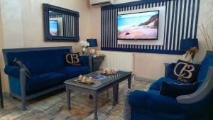 a living room with blue couches and a table at BALPETEK HOTEL in Istanbul