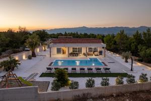 an aerial view of a house with a swimming pool at Villa Olea Pridraga ZadarVillas in Pridraga