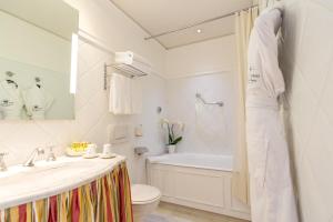 a bathroom with a tub and a sink and a toilet at Hotel Splendid in Cannes