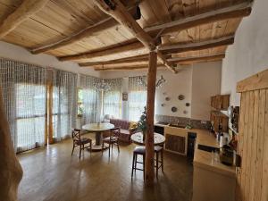 a kitchen and living room with a table and chairs at Nature Sanctuary, a semi-detached house on an ecological & sustainable farm in Santa Maria de Guia de Gran Canaria +33 photos