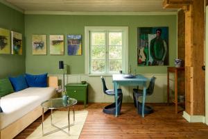 a living room with a couch and a table at Charming Apartment In Artists Home From 1899 in Lönsboda