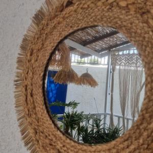 a mirror reflection of a window with a blue curtain at Blue Cactus village center in Agia Pelagia