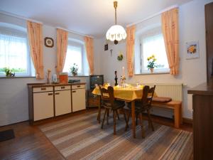 a kitchen and dining room with a table and chairs at Ferienhaus in der Nähe der Skipiste in Stadlern