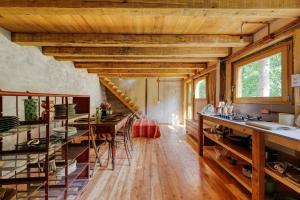 a kitchen with wooden ceilings and a table with chairs at Natural Riverside Retreat In Tiglieto in Tiglieto +22 photos