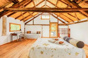 a bedroom with a large bed in a room with wooden ceilings at Natural Riverside Retreat In Tiglieto in Tiglieto