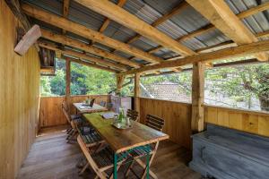 a wooden dining room with a table and chairs at Natural Riverside Retreat In Tiglieto in Tiglieto
