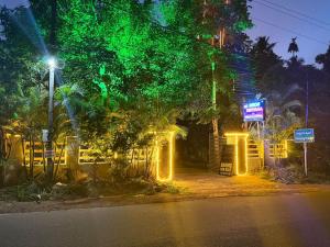 a city street at night with green lights at Neon Nirvana in Varkala +10 photos