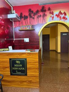 an entrance to a room with palm trees on the wall at Neon Nirvana in Varkala