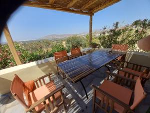 a table and chairs on a patio with a view at Katzilieris Country House in Naxos Chora