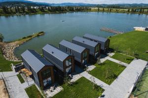 an aerial view of a house on a lake at Apartamenty Na Stawach 24 in Stary Sącz