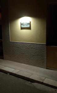 a sign on the side of a building at night at Thysia in Conversano +6 photos
