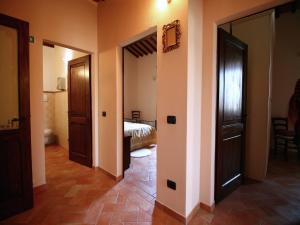 - un couloir avec deux portes et un lit dans une chambre dans l'établissement Lovely Farmhouse in Asciano with Swimming Pool, à Asciano 66 autres photos