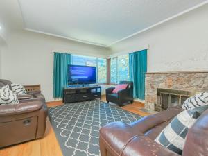 a living room with a couch and a television at Cozy Airb&b Suite in South Vancouver in Vancouver