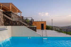 a house with a swimming pool with stairs and a building at Aprie Boutique Hotel in Byurakan