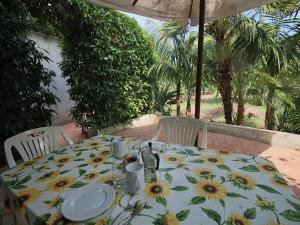a table with a table cloth with sunflowers on it at Spacious Mansion in Parghelia near Sea in Parghelia