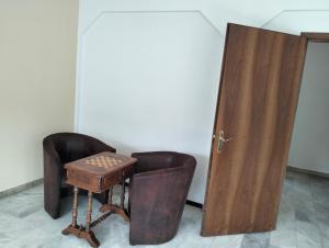 a room with a table and two chairs and a door at Villa Caslano in Caslano