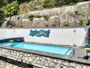 a swimming pool on a wall with graffiti on it at Villa Caslano in Caslano