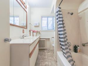 a bathroom with a sink and a tub at Cozy Airb&b Suite in South Vancouver in Vancouver +6 photos