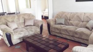 a living room with two couches and a coffee table at Caribbean Estates Montego Bay 05 in Port Edward +12 photos