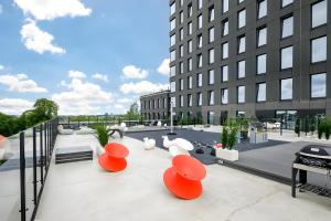 a view of a building with orange chairs on a patio at Luxury apartment, outstanding view, free parking in Tallinn +4 photos