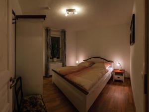 a bedroom with a large bed in a room at Bright apartment in Thale with terrace in Thale +2 photos